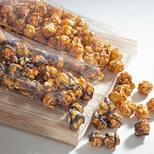 Caramel and chocolate-drizzled popcorn on a wooden board.