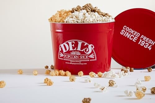 Red Del's Popcorn Shop bucket with popcorn and lid.